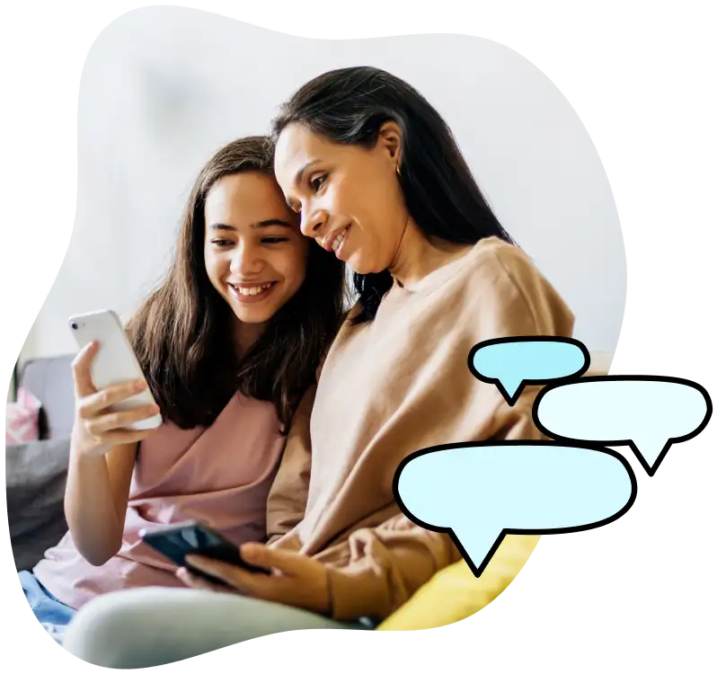 A young, teen girl shares her phone screen with her mother.